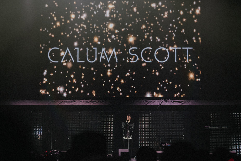 Calum Scott singing on stage at the Liverpool Echo Arena