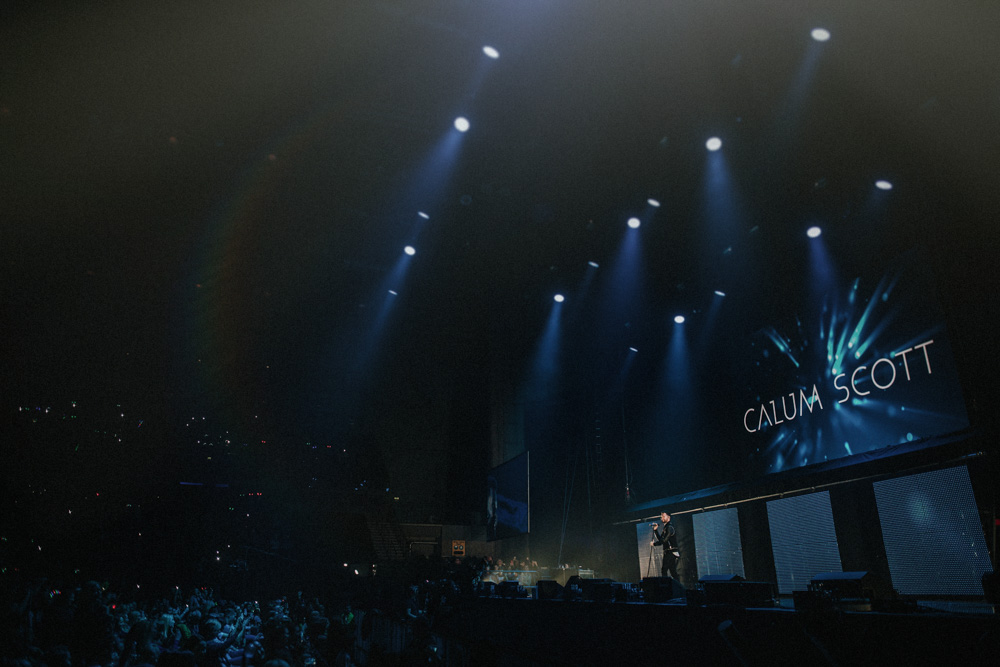 Photograph of Calum Scott performing on stage at the Liverpool Echo Arena