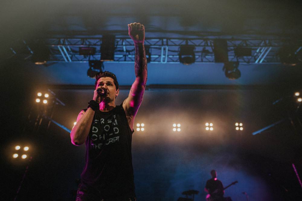 Danny from The Script singing to the crowd with arm in air